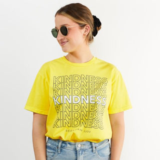 Image of a model wearing the beekman 1802 kindness t shirt tucked in while wearing sunglasses and looking off to the side. 