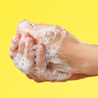 an image of washing hands that are covered in suds.
