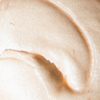 A closeup texture shot of Beekman 1802's Pot of gold goat milk whipped body cream.